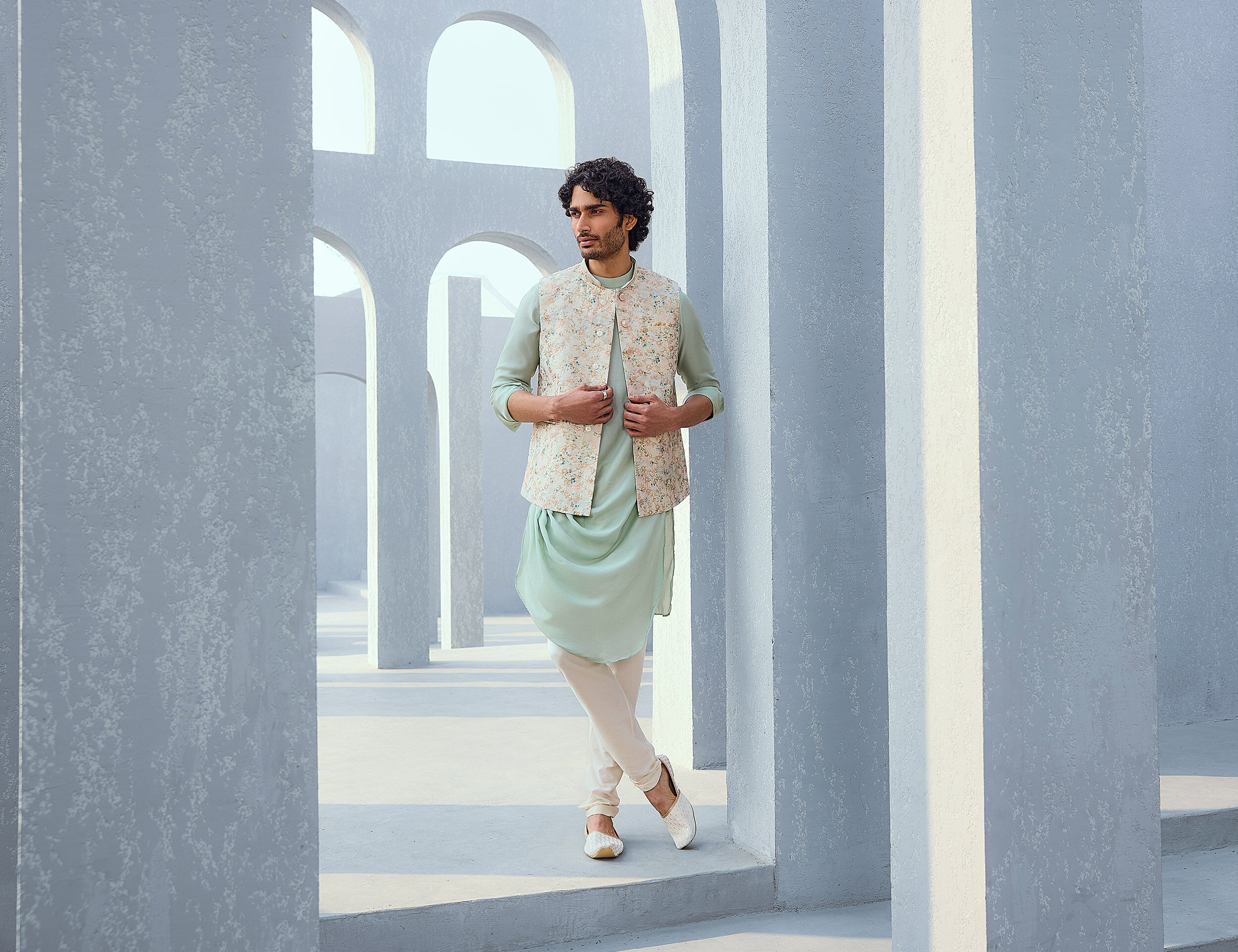 A man wearing a Light green Kurta Pajama set with printed jacket for engagement ceremony